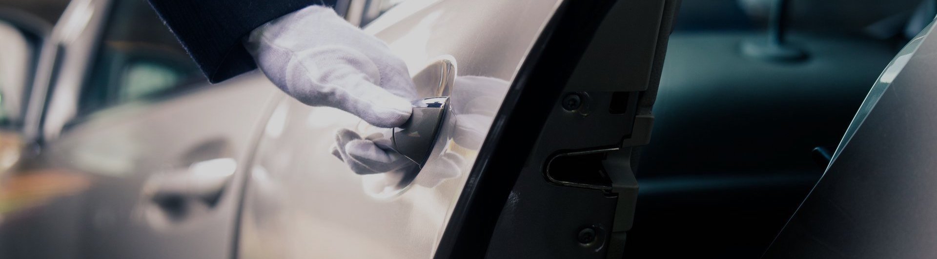 best-rated-limousine-service-connecticut A gloved hand opens a car door from the outside, showing part of the vehicle's interior and side mirror.